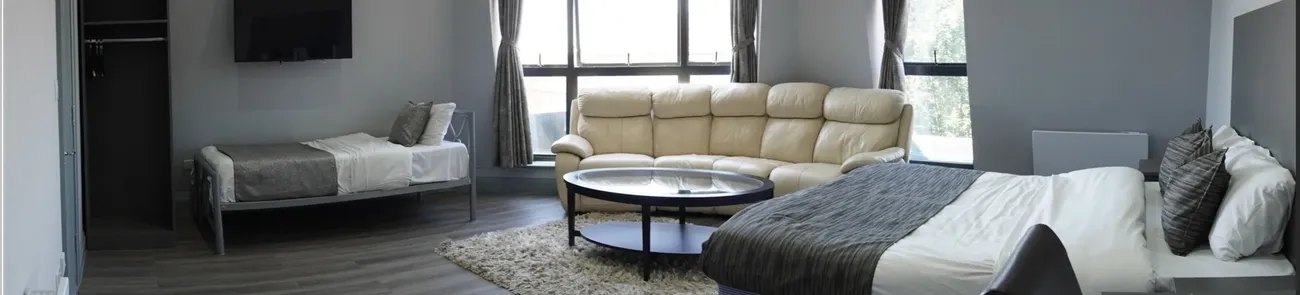 Family room with lounge seating at Roshni Hotel